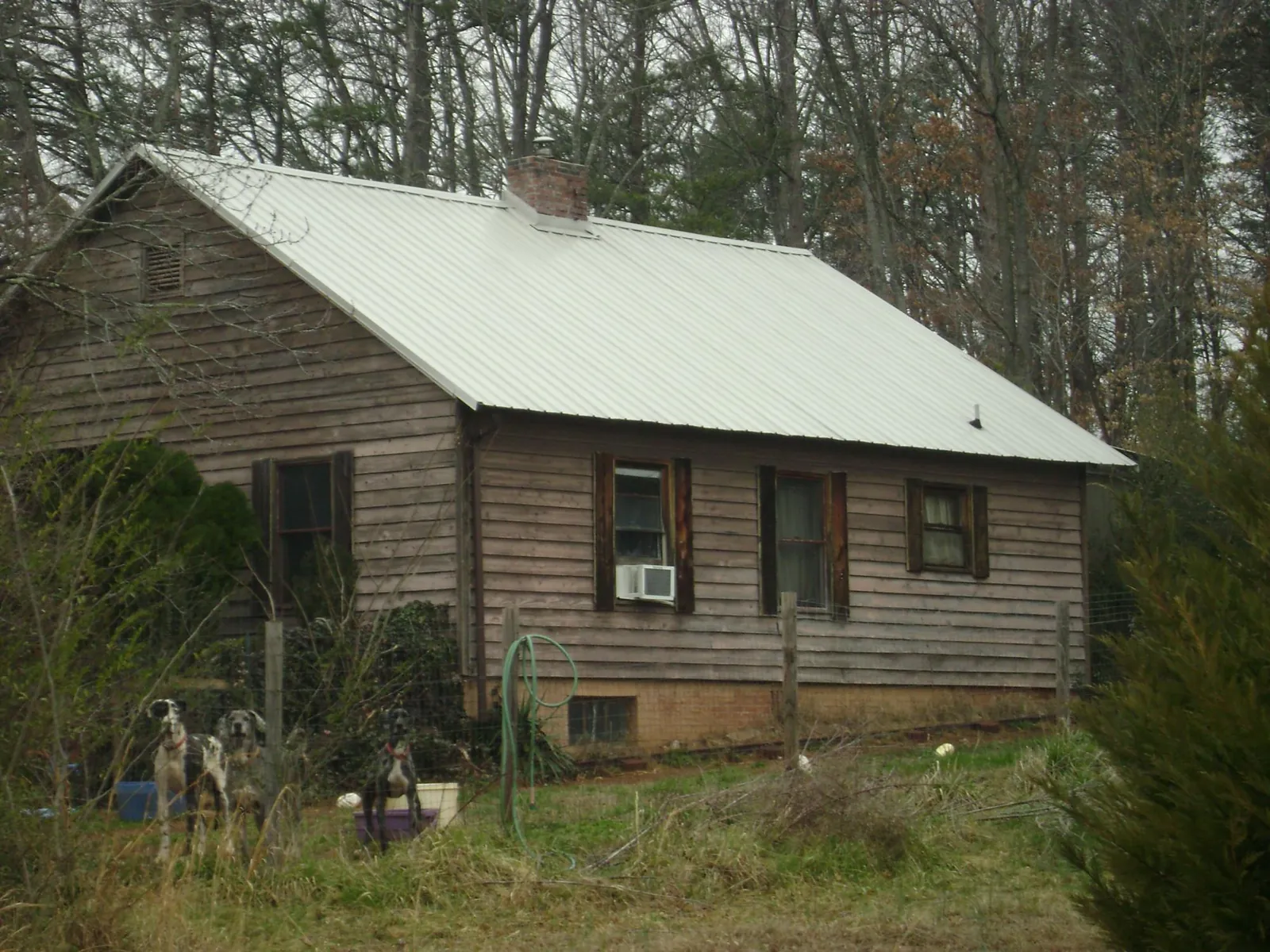 White metal roof on an old wood sided farmhouse, from a Asphalt Shingle Roof Repair job in Patton